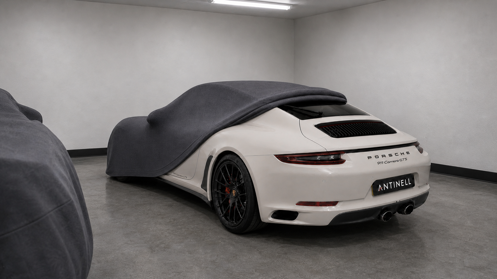 Crayon Porsche 911 stored securely alongside another covered vehicle
