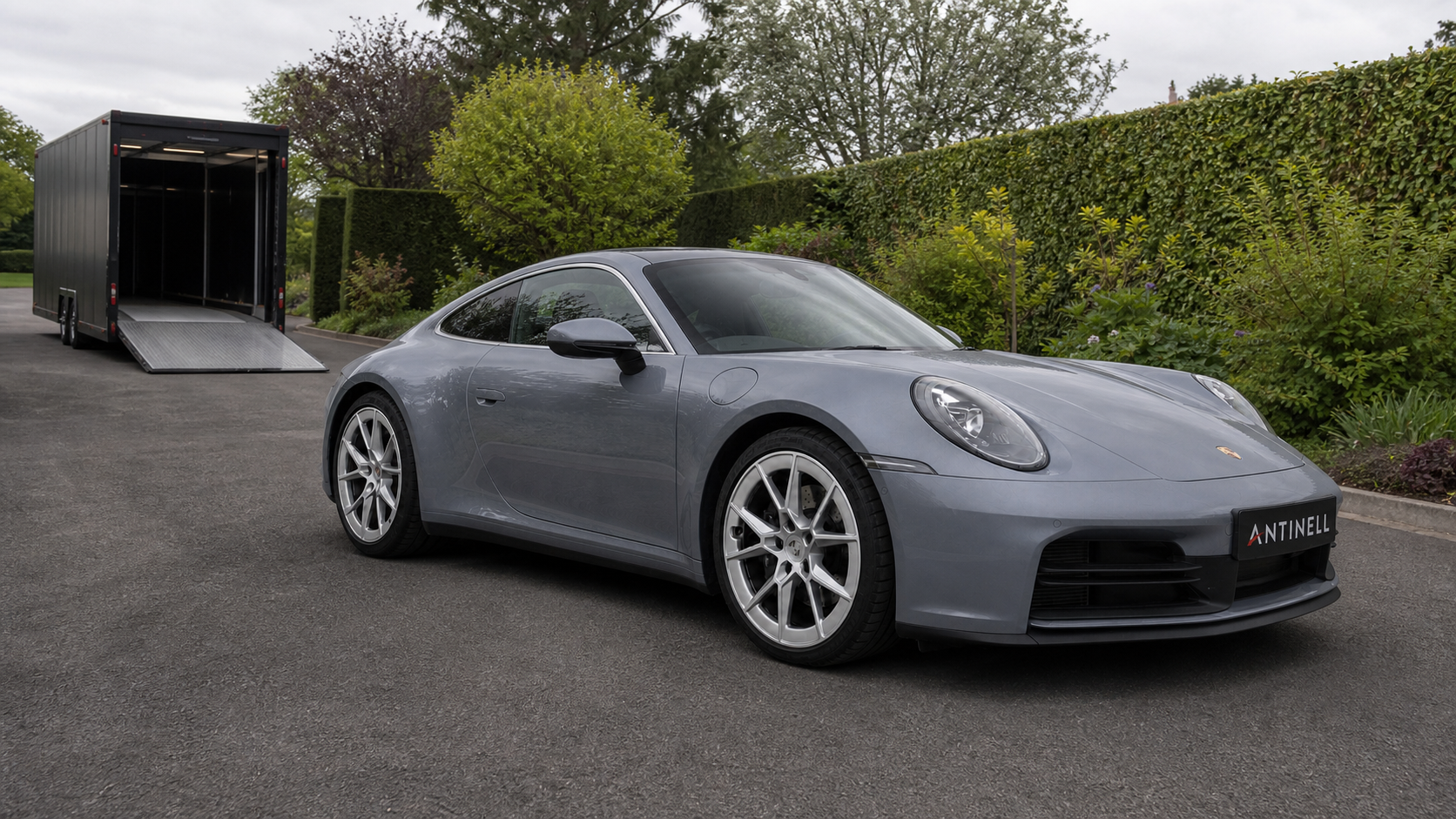 Graphite-grey Porsche 911 awaiting discreet enclosed collection