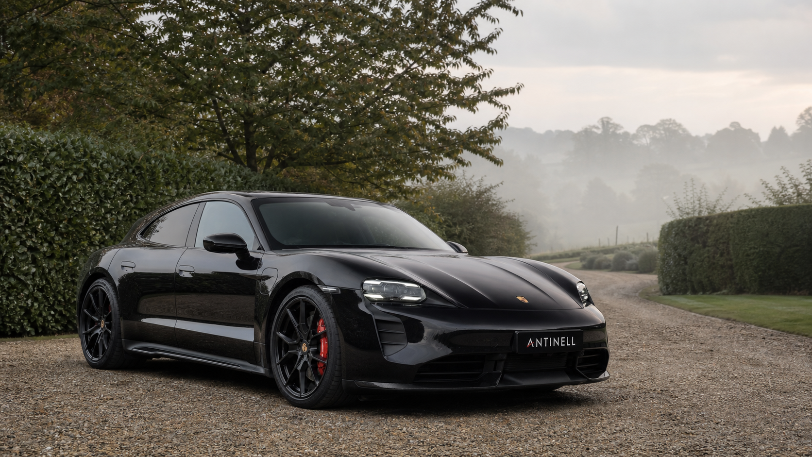 Black Porsche Taycan GTS Sport Turismo on a private Surrey drive